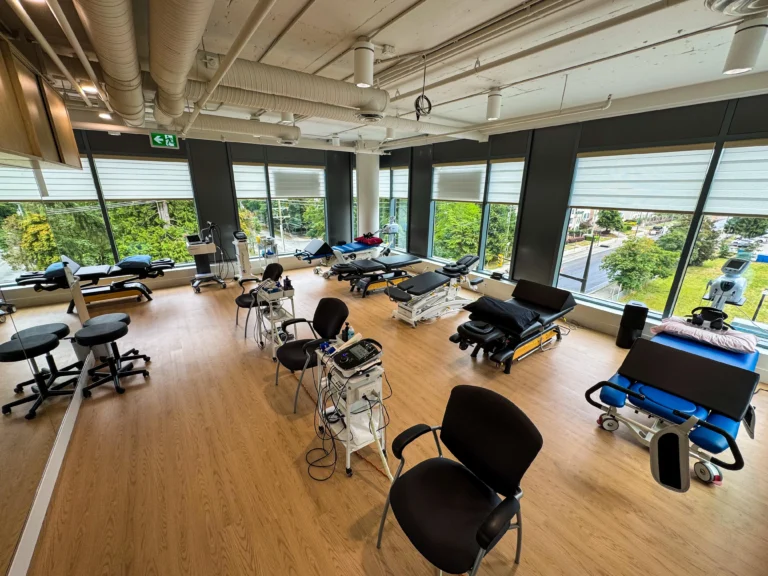 Aerial view of a physiotherapy space featuring various treatment machines, seating areas, and treatment tables arranged in a well-organized layout.